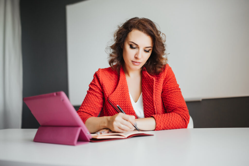 businesswoman in office working with digital tablet and other documents. beautiful modern business woman in office on background.